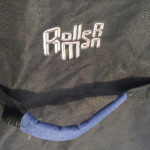 detail of the rollerman logo near the handle of big blue bag designed by Jean Yves Blondeau