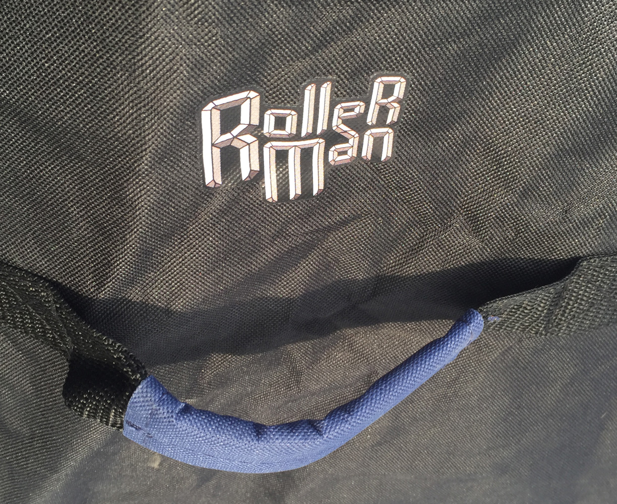 detail of the rollerman logo near the handle of big blue bag designed by Jean Yves Blondeau