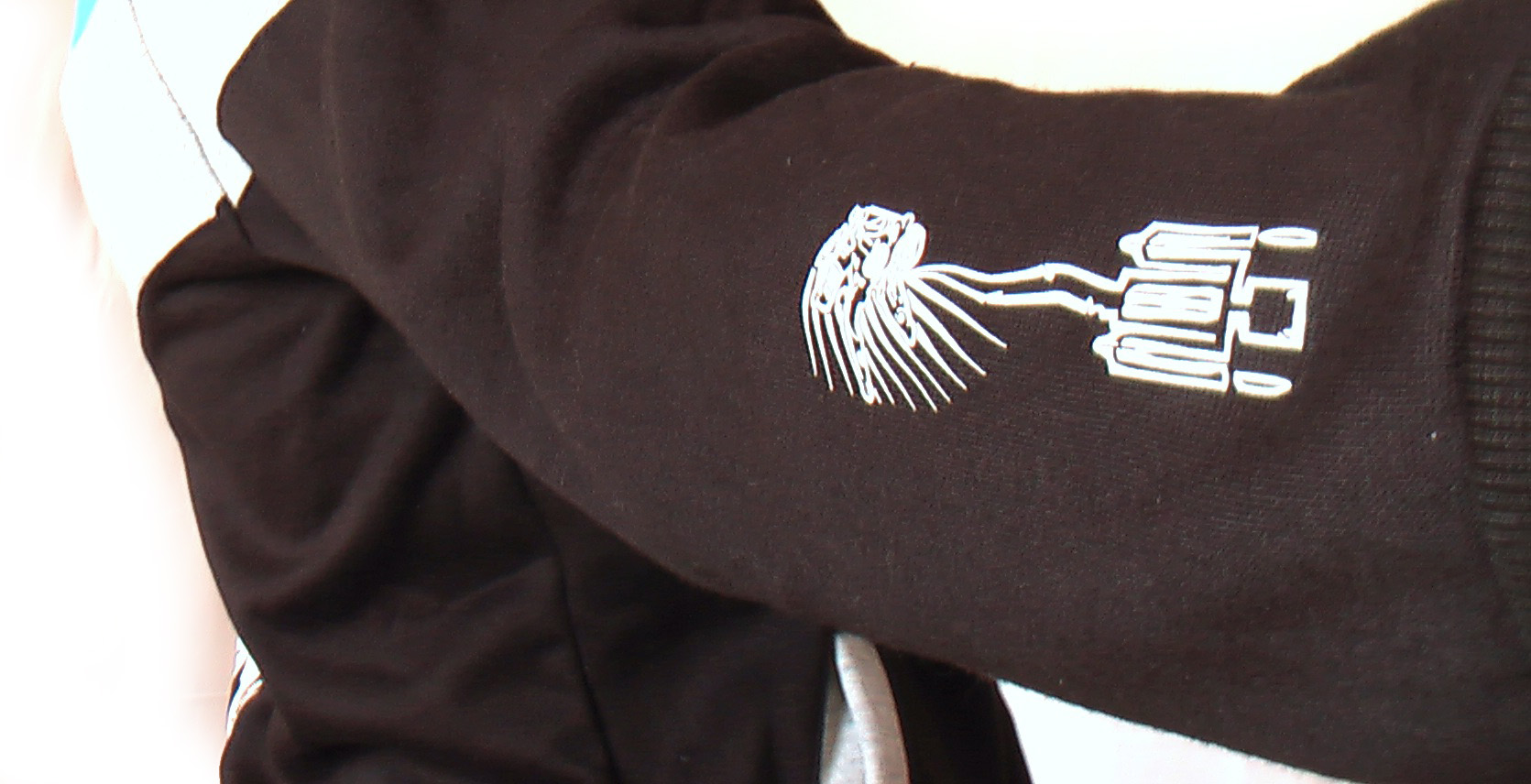 sleeve detail of scrape pilot on sleeve of buggy rollin team hoodie designed by Jean Yves Blondeau